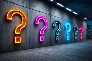 Many neon questions hanging on a concrete wall in empty underground space photo