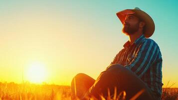 Sunset contemplation by a cowboy in an open field on a tranquil evening, appreciating nature's beauty photo