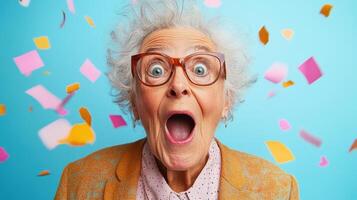 Excited senior woman celebrating with colorful confetti during a joyful party atmosphere in a vibrant indoor setting photo