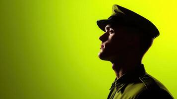 Profile of a military officer against a vibrant green background during sunset capturing the essence of duty and honor in uniform photo