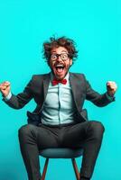 Excited man in suit with messy hair and glasses celebrating against bright turquoise background during cheerful mood photo