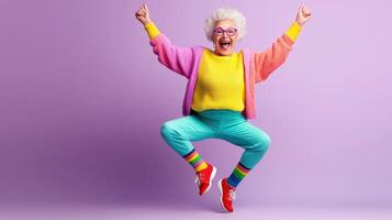 Joyful elderly woman jumping in colorful outfit celebrating positivity and happiness in a vibrant studio setting photo