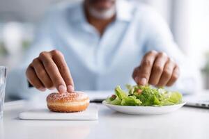 Balancing choices during lunch break at the office between donuts and salad photo