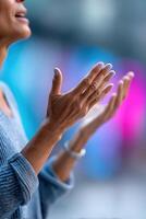 Hands gesturing passionately against a colorful backdrop during a lively speech event photo