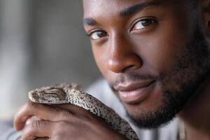 Wildlife photography session with a relaxed Black adult and a friendly snake photo