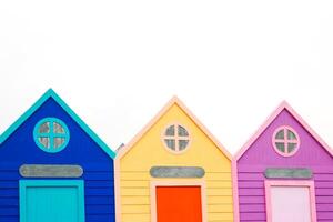 Three Colorful Beach Huts in a Row Against a Bright White Sky, Perfect for Summer Vacation photo