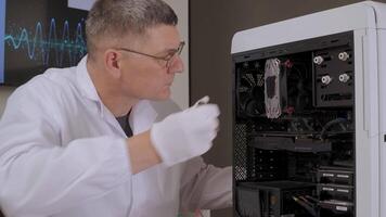 ngineer repairing motherboard at lab desk with electronic tools, Middle-aged man in lab coat fixing computer hardware near open desktop case video
