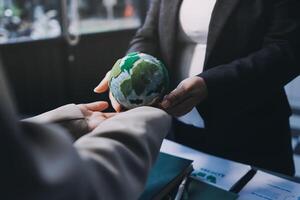A person holding a globe in their hand photo