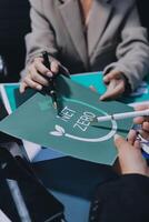 Business people holding a green paper with the word zero on it photo