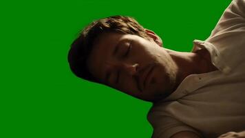 Man sleeping soundly in a room with a green screen backdrop video