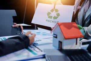 Recycling concept business people holding paper with recycle symbol on it photo