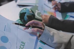 Business people working on papers with a globe on top photo