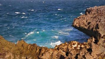 Sharp rocky cliff with waves video