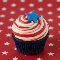 Patriotic swirl cupcake with blue star decoration for fourth of july photo