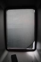 A square window in a dark room photo