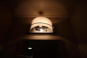A light is shining on a light fixture in a bathroom photo