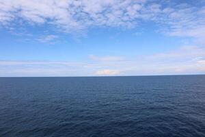 A large body of water with a boat in the middle photo