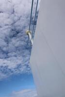 A view of a white building with a blue sky photo