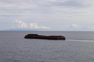 A large boat floating in the ocean photo