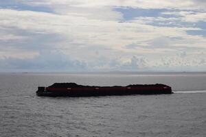 A large boat floating in the ocean with a red line photo