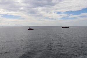A boat is in the middle of the ocean photo
