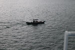 A small boat is floating in the water photo