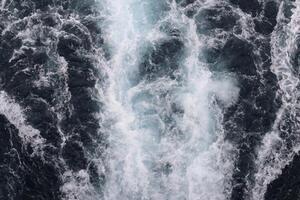 A large wave is crashing into the ocean photo