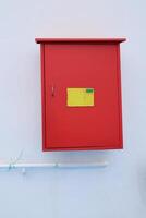 A red box with a yellow sticker on it photo