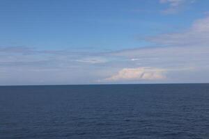 A large body of water with a small boat in it photo