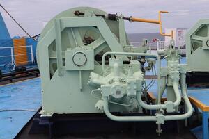 A large blue boat with a large engine on it photo