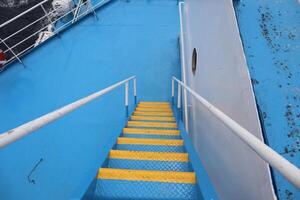 A blue boat with yellow steps photo