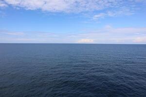 A large body of water with a small boat photo