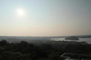 A view of a lake and a city from a hill photo