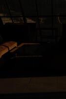 A man is sitting in a chair in a dark room photo