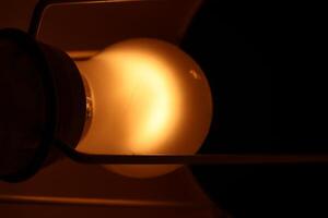 A light bulb is lit up in the dark photo