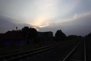 A train track with a building in the distance photo