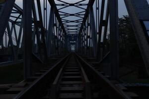A train track on a bridge at dusk photo