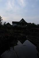 A house in the distance with a reflection of the sky photo