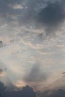 A plane flying through the sky with clouds photo