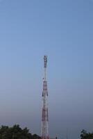 A tower with a red and white antenna photo