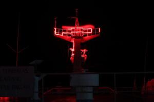 A red light on a tower at night photo