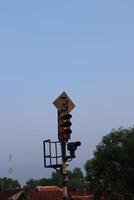 A traffic light on a pole with a sign photo