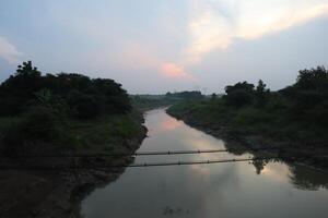 A river with a bridge over it photo