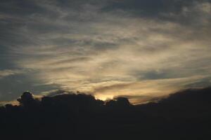 A plane flying in the sky with clouds photo