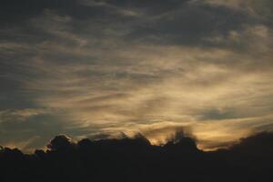 A plane flying in the sky with clouds in the background photo