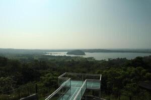 A glass walkway over a lake photo