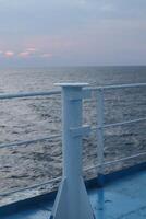 The view from the deck of a ship at sunset photo