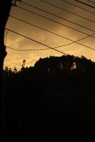A sunset view from the window of a train photo