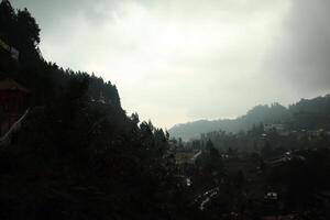 A view of a mountain range with a small town in the distance photo