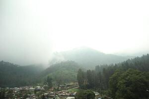 A view of a mountain range with a village in the distance photo